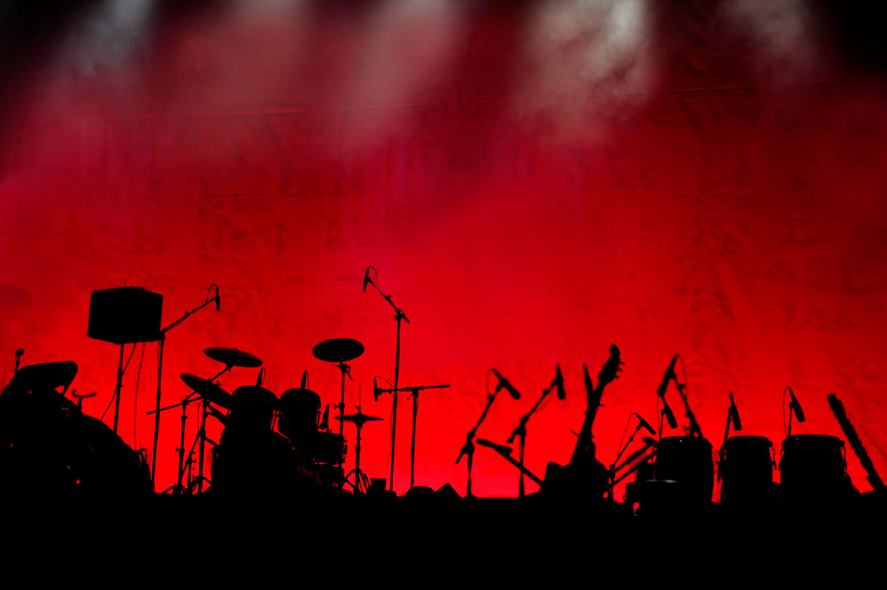 Photo of instruments on stage between bands at a concert.